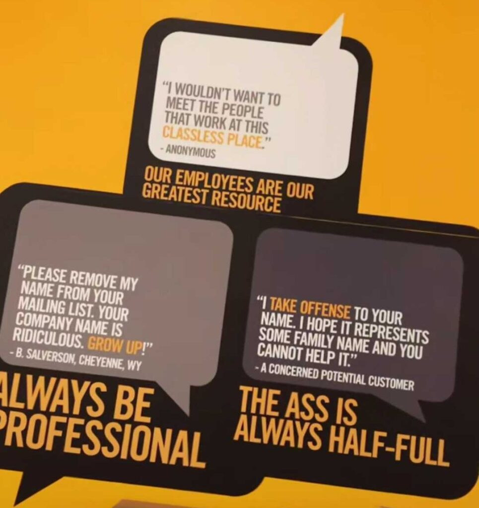 Signs at the Big Ass Fans headquarters featuring negative reviews like "I wouldn't want to meet the people that work at this classless place" and "your company name is ridiculous. Grow up!" and "I take offense to your name"