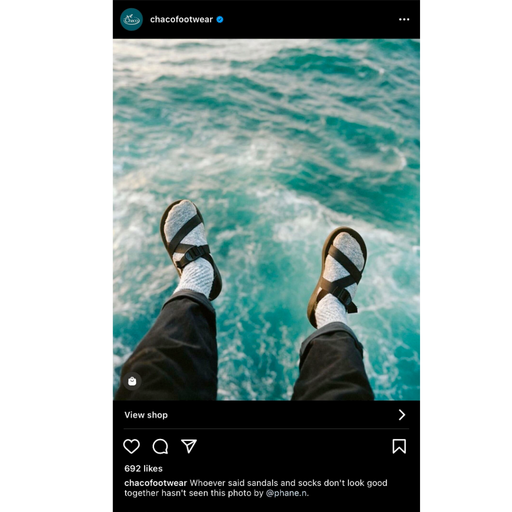 Chaco re-sharing UGC of a person's feet – wearing Chaco sandals – dangling over the ocean